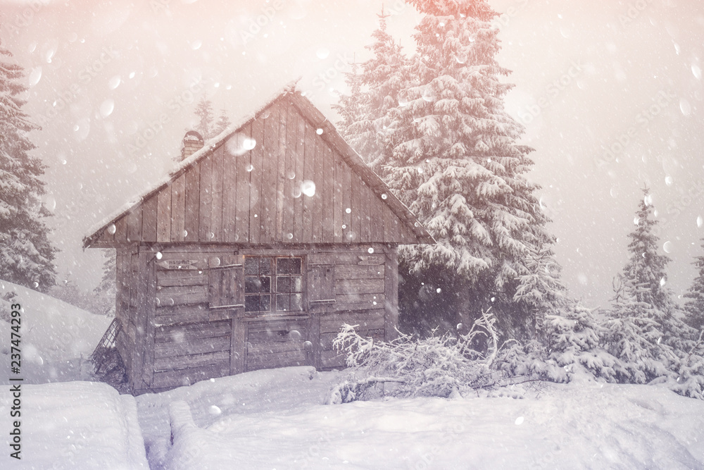 Fantastic winter landscape with wooden house in snowy mountains. Christmas holiday postcard collage.