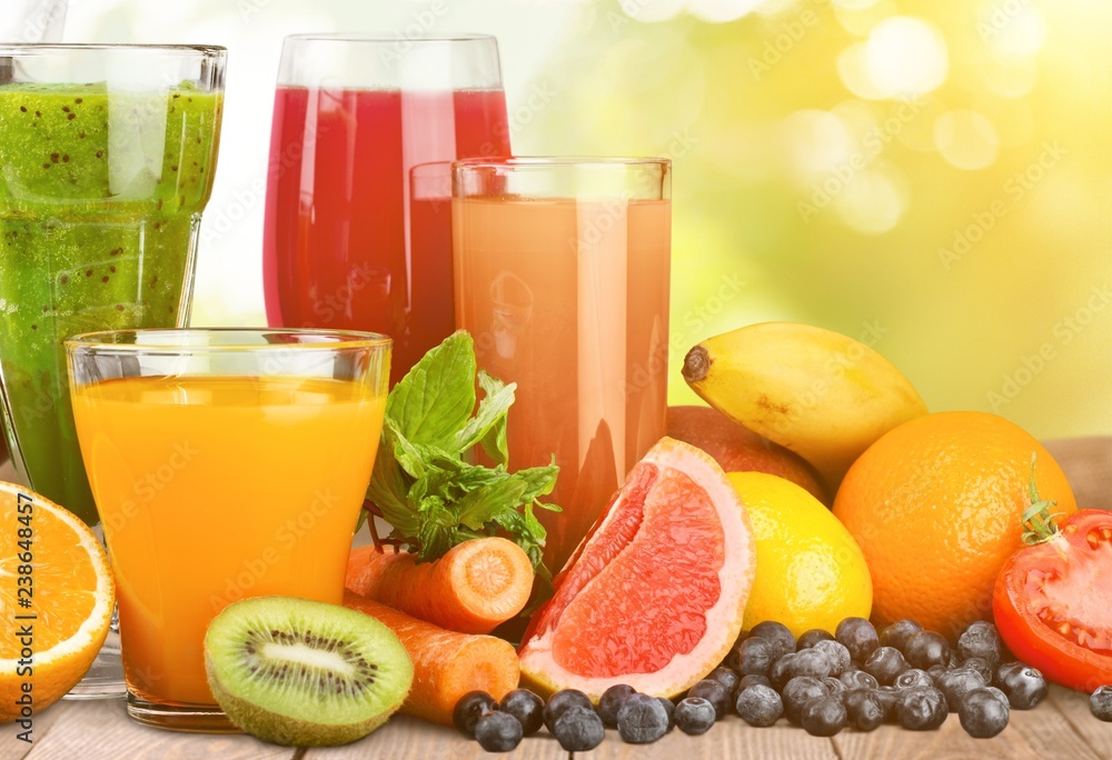 Fresh ripe healthy fruits and juices in glasses