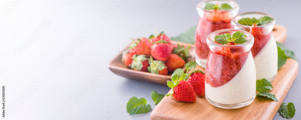 Delicous and nutritious double color (colour) strawberry desserts with mint and diced sarcocarp topp