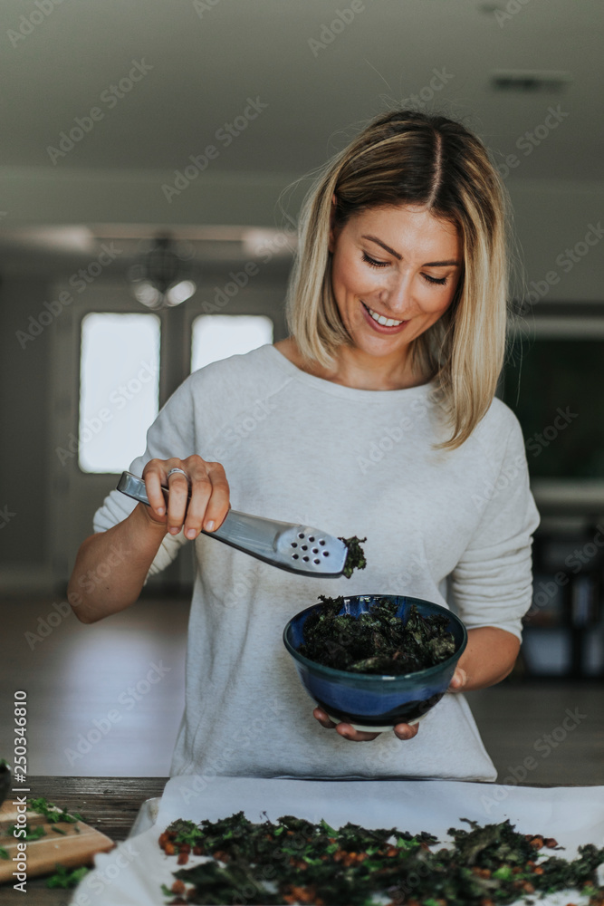 Woman serving fried kale and chickpeas