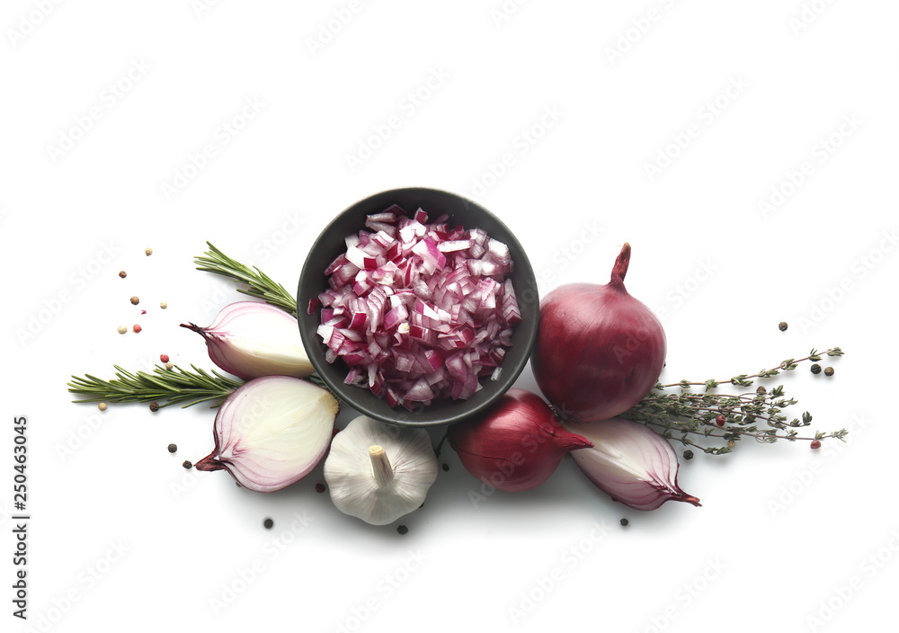 Bowl with raw onion, herbs and spices on white background
