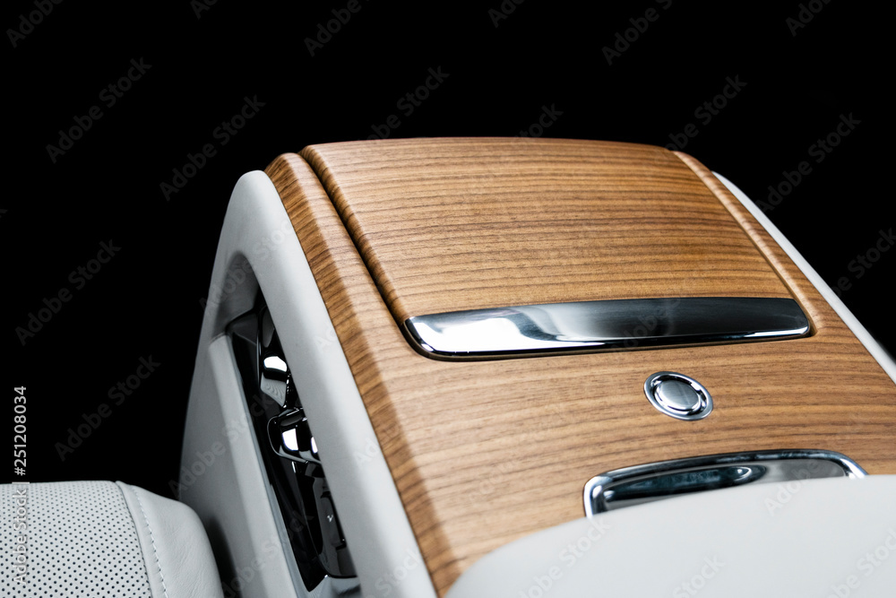 Modern luxury car white leather interior with natural wood panel. Part of leather car seat details w