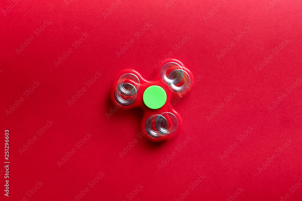 Stroboscopic photo of moving spinner on color background