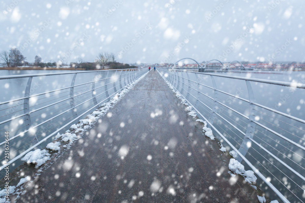 Solvesborgsbron pedestrian bridge with falling snow in the south of Sweden
