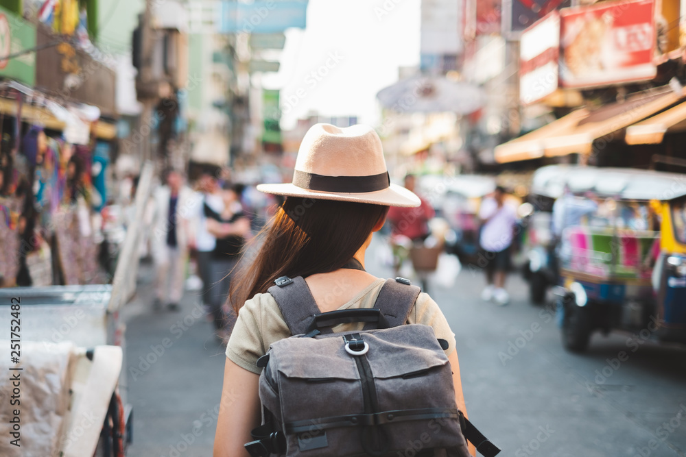 Back view Asian woman tourist backpacker travel in Khao San road, Bangkok, Thailand