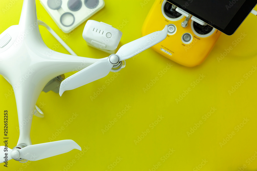 Drone equipment with Remote control on yellow paper background, copy space for your text Top view im