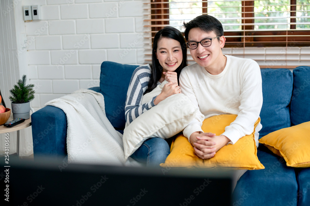 happiness asian sweet couple enjoy tv program show on television together living room home backgroun