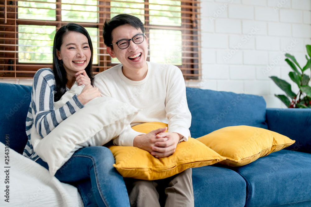 happiness asian sweet couple enjoy tv program show on television together living room home backgroun