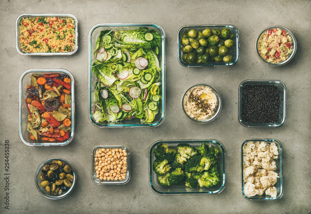 Healthy vegan dishes in containers. Flat-lay of vegetable salads, legumes, beans, fermented olives, 