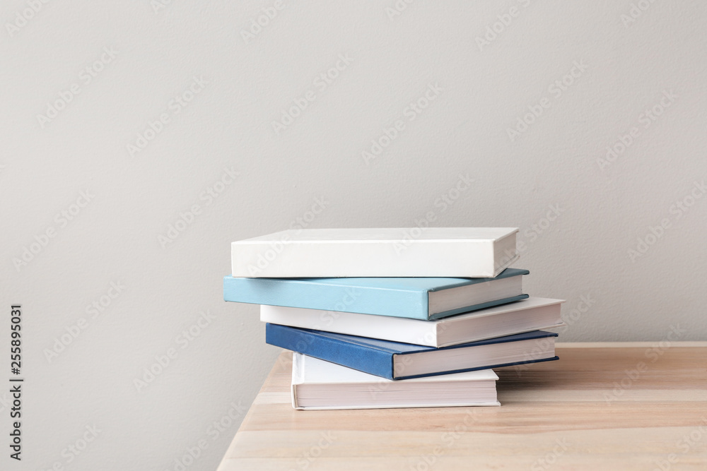 Many books on table against light background