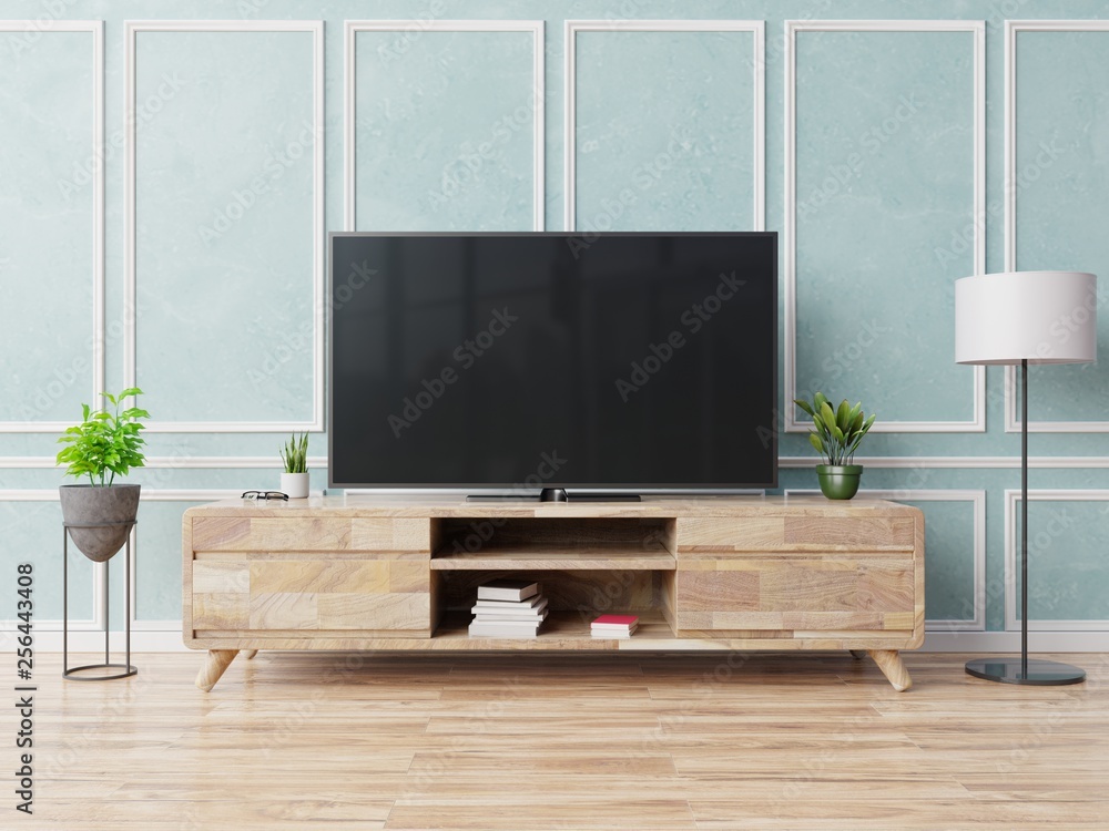 Smart tv on cabinet in modern living room on blue wall background,3d rendering