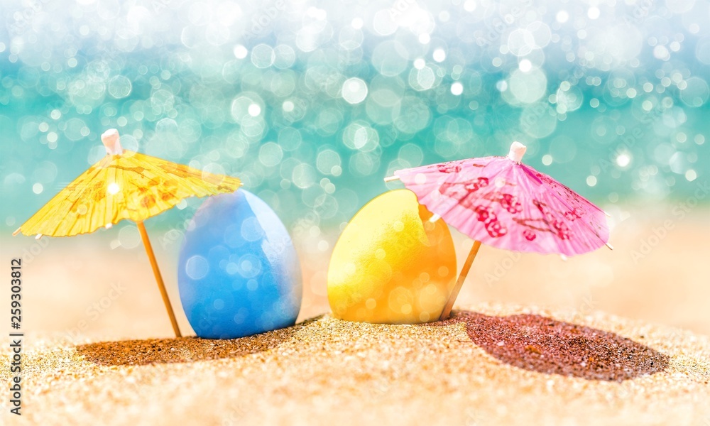 Colorful easter eggs on ocean beach