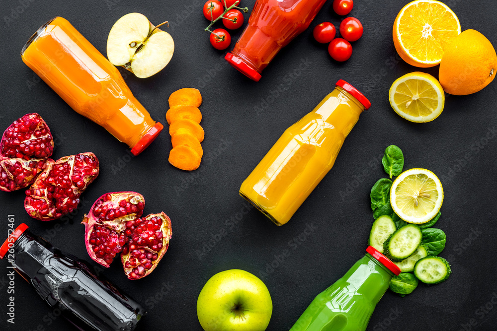 fresh organic juices in bottles for fitness diet on black background top view mock-up