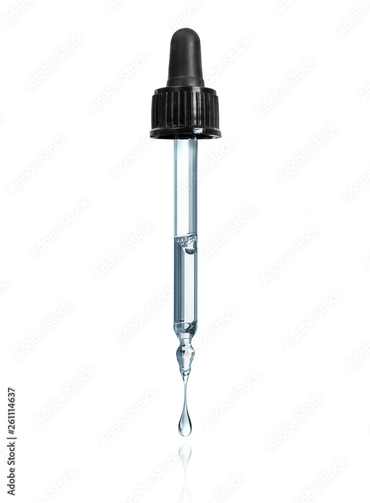 Thick drop is dripping down from cosmetic pipette isolated on a white background