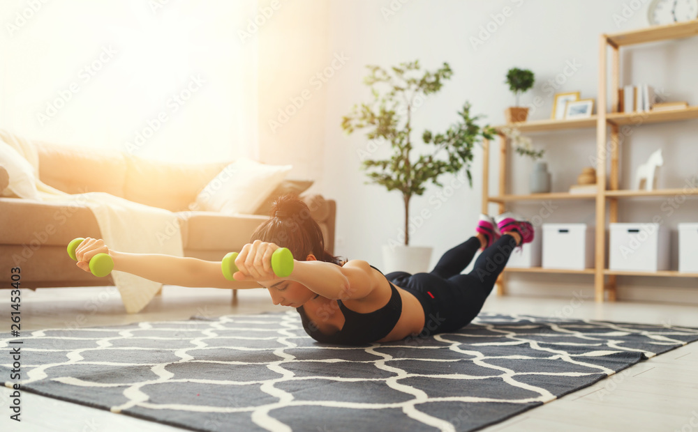 young woman doing fitness and sports at home