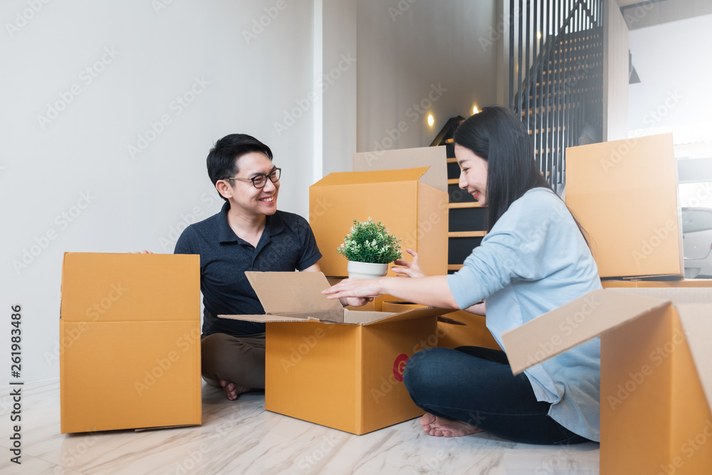 亚洲家庭搬到有很多包装箱的新家/公寓