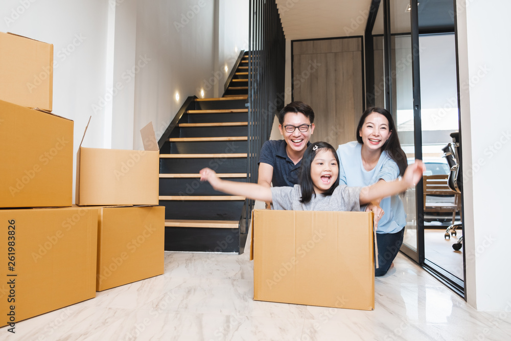 Asian family moving to new home / apartment with many packing boxes