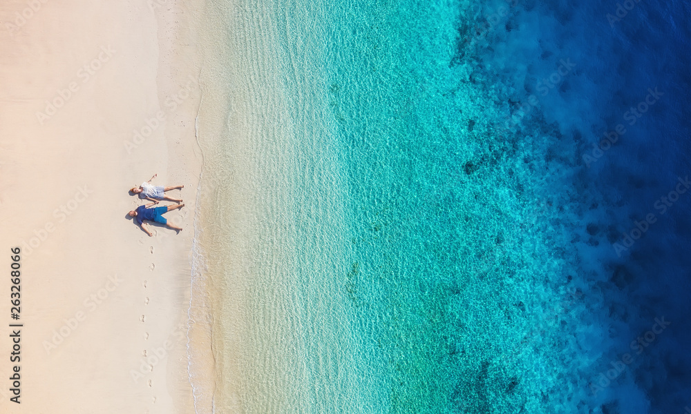 Aerial view of a people couple on the beach on Bali, Indonesia. Vacation and adventure. Beach and tu