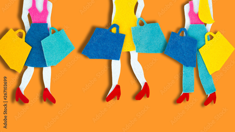 Female legs with shopping bags over bright background
