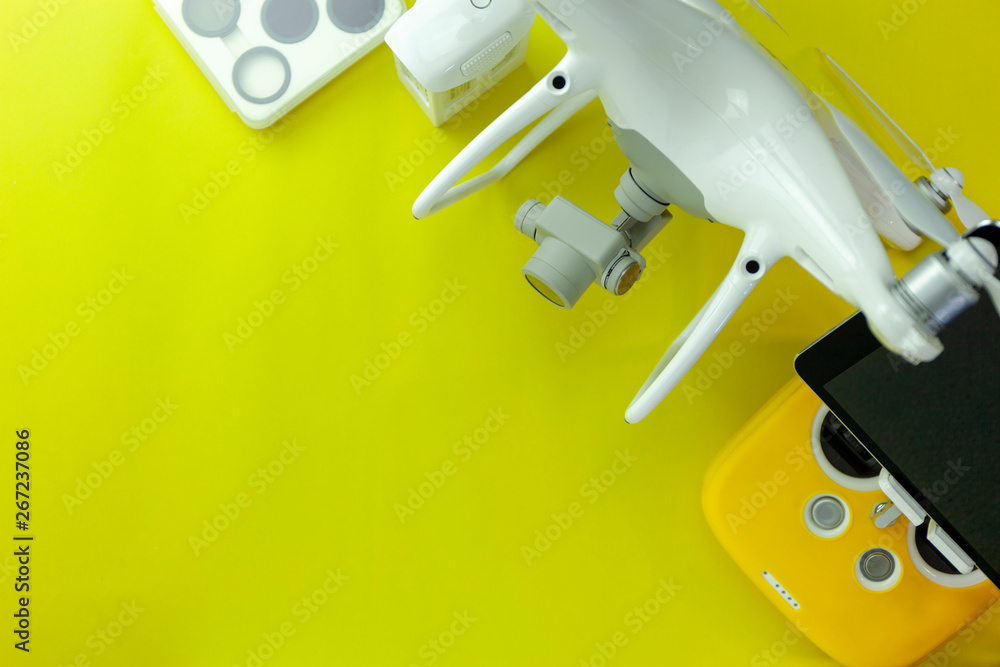 Drone equipment with Remote control on yellow paper background, copy space for your text Top view im