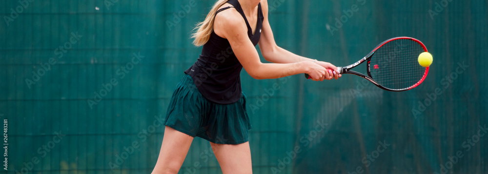 Midsection Of Woman Playing Tennis In Court