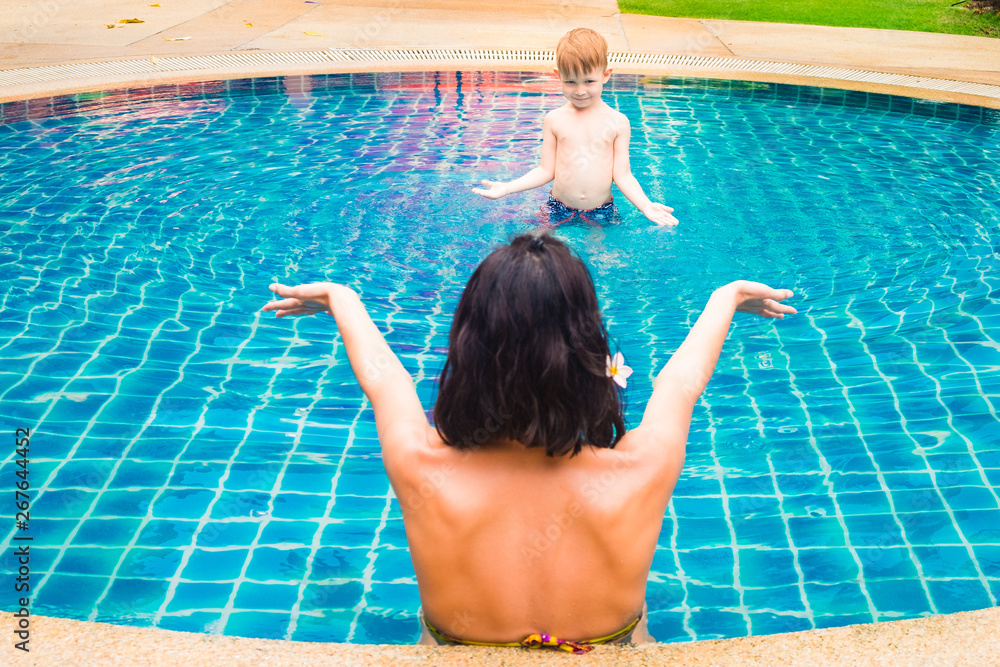 Mom and son playing in the pool