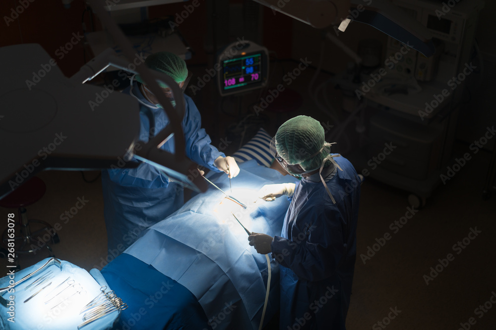 Asian doctor and an assistant in the operating room for surgical venous vascular surgery clinic in h