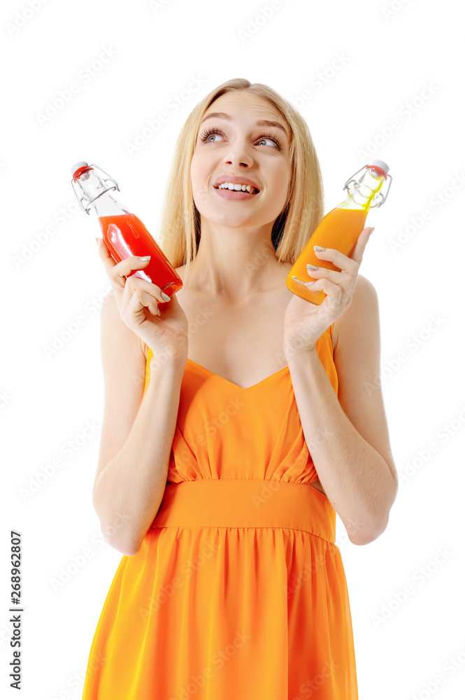 Beautiful young woman with bottles of juice on white background