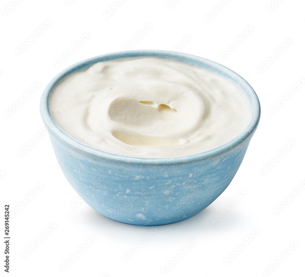 Sour cream or yogurt isolated on white background. Blue bowl of yoghurt.