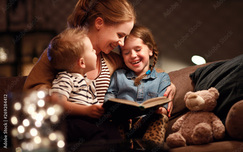 evening family reading. mother reads children . book before going to bed