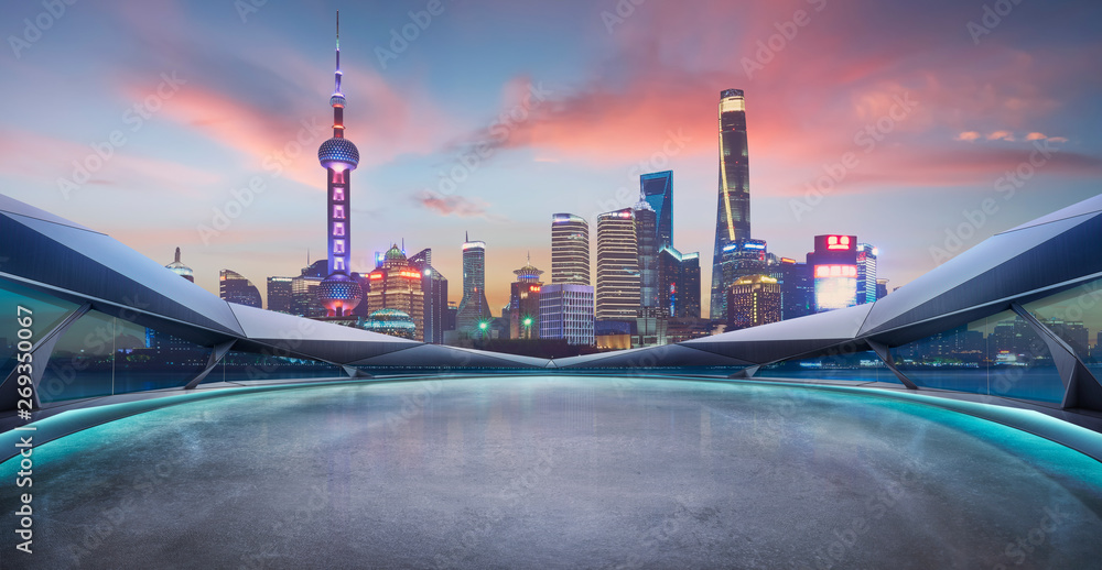 Panoramic view of futuristic geometric shapes design empty floor with Shanghai city skyline . Sunset