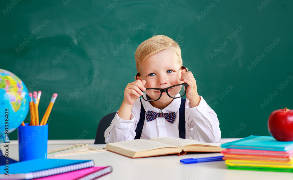 the child   schoolboy  boy student about school blackboard.