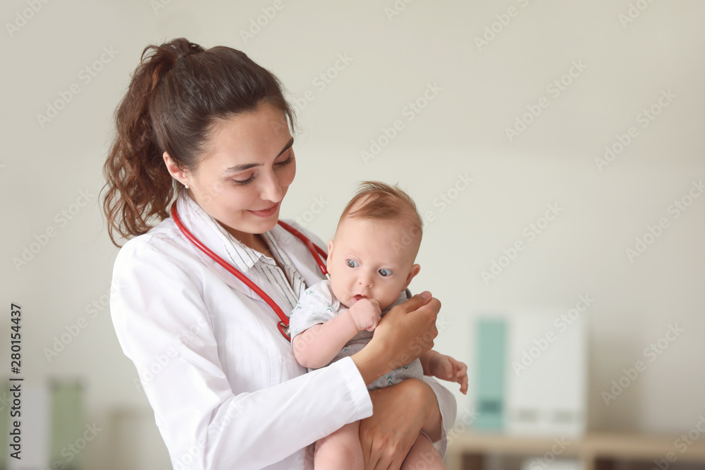 Pediatrician with cute little baby in clinic