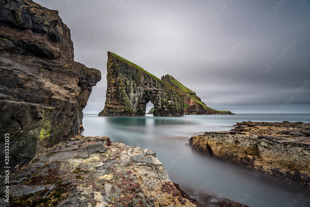 Amazing ultra wide angle long exposure of Drangarnir gate in front of Tindholmur, Faroe Islands