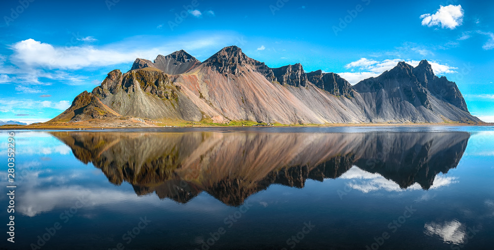 Splendid sunny day and gorgeous reflection of Vestrahorn mountaine on Stokksnes cape in Iceland.