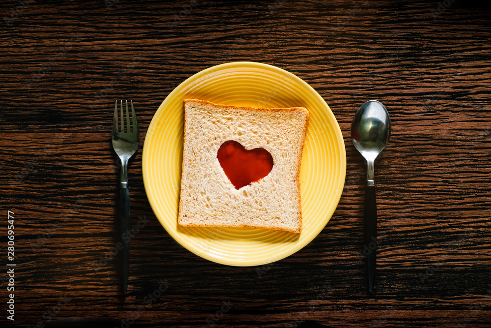 Love and Romance Concept. Bread on Plate with Spoon and Fork in Breakfast Time. Heart Shape with Tom