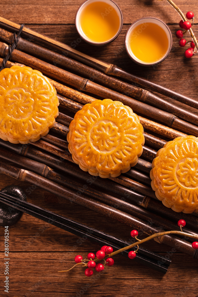 Moon cake Mooncake table setting - Chinese traditional pastry with tea cups on wooden background, Mi