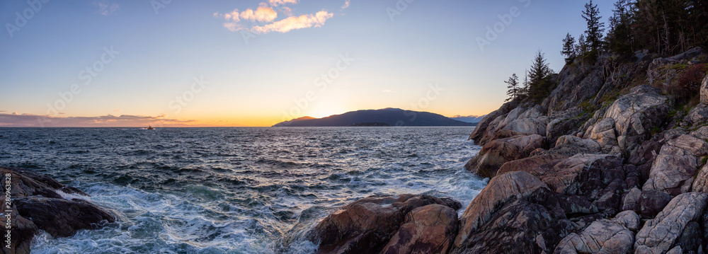Beautiful Panoramic view of a rocky ocean coast during a vibrant sunny sunset. Taken in Lighthouse P