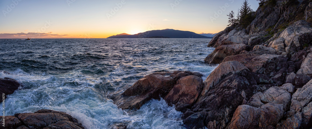 Beautiful Panoramic view of a rocky ocean coast during a vibrant sunny sunset. Taken in Lighthouse P