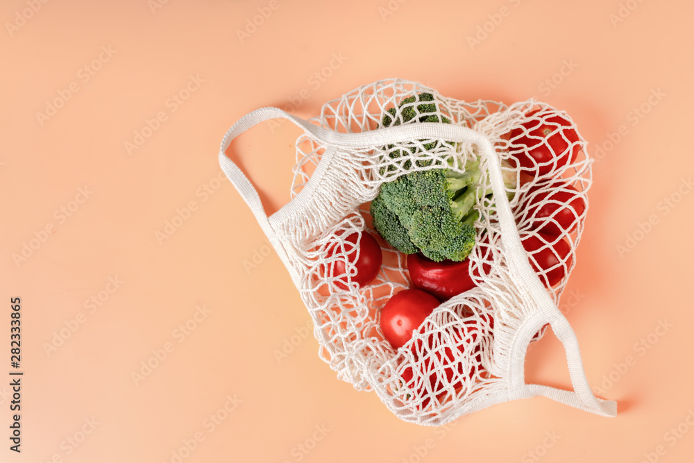 Top view of white eco net bag with vegetables