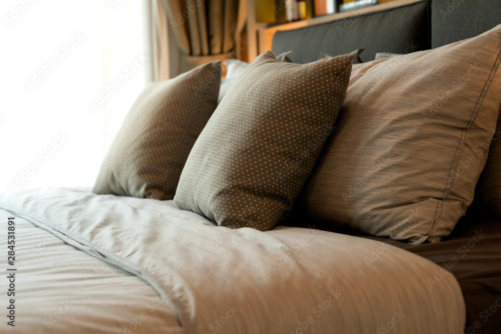close up white beige soft pillows on bed and blanket bedroom interior design concept.bed maid luxury