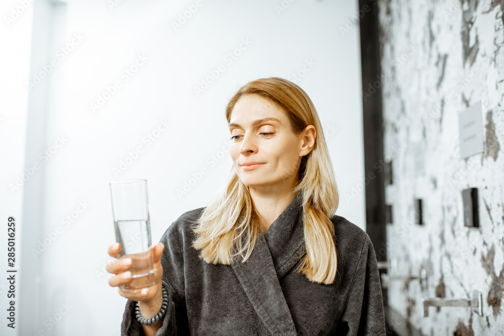Woman drinking mineral water at the pump-room