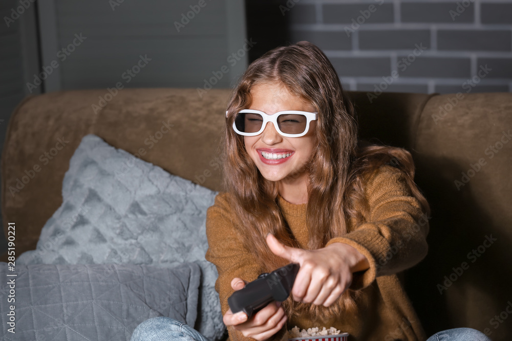 Teenage girl playing video game late at night