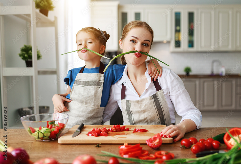 happy family mother with child girl preparing vegetable salad