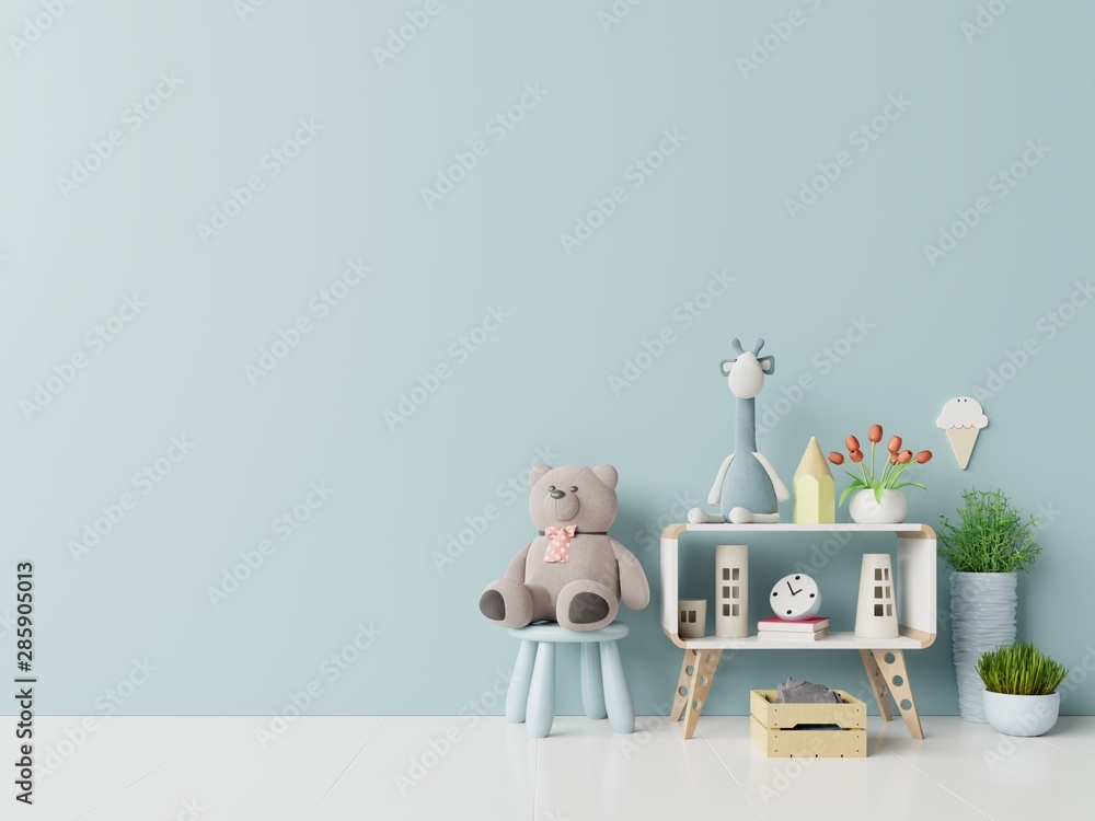 Teddy bear and rabbit doll in the childrens room on blue wall background.