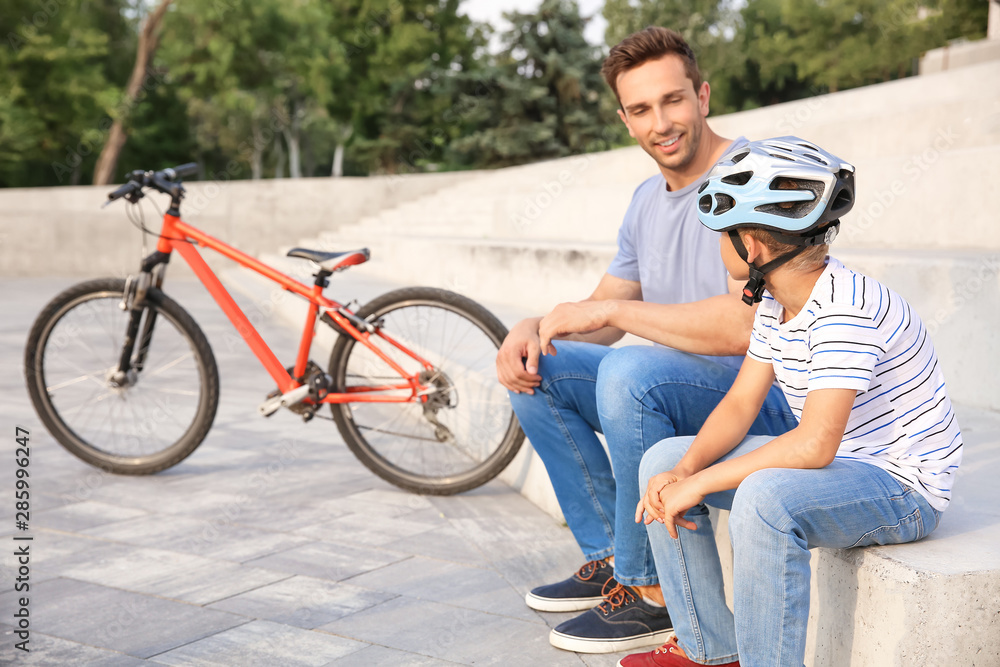 父亲和他的小儿子在户外骑自行车