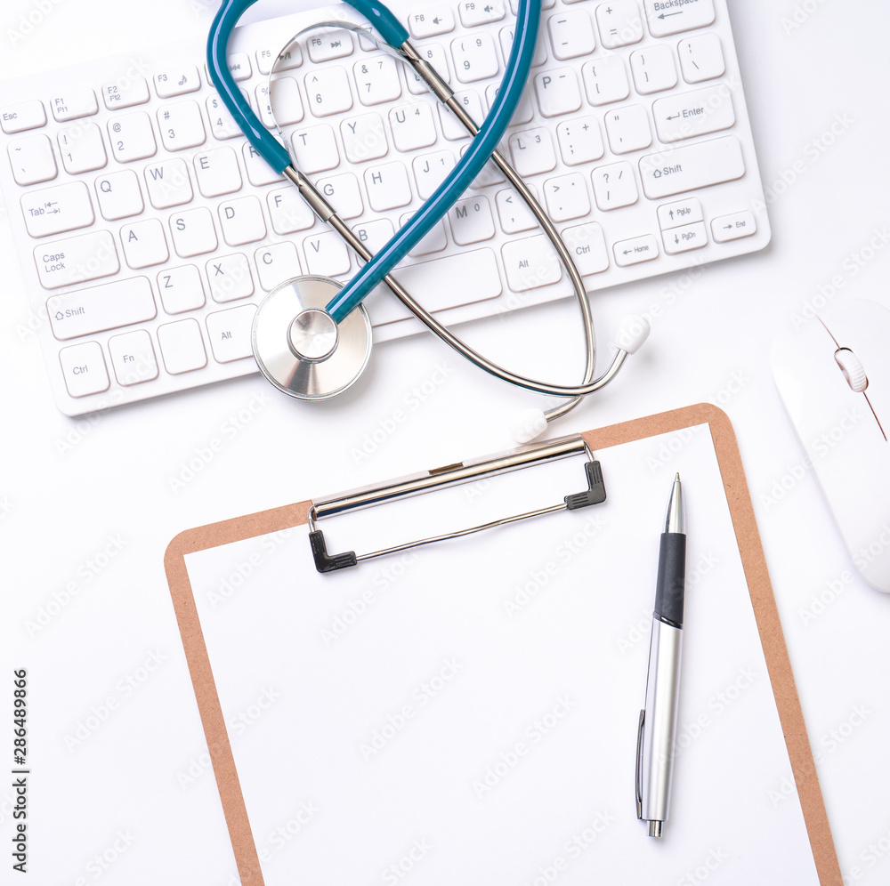 医生诊断概念-电脑键盘上的听诊器，带病历箱和笔