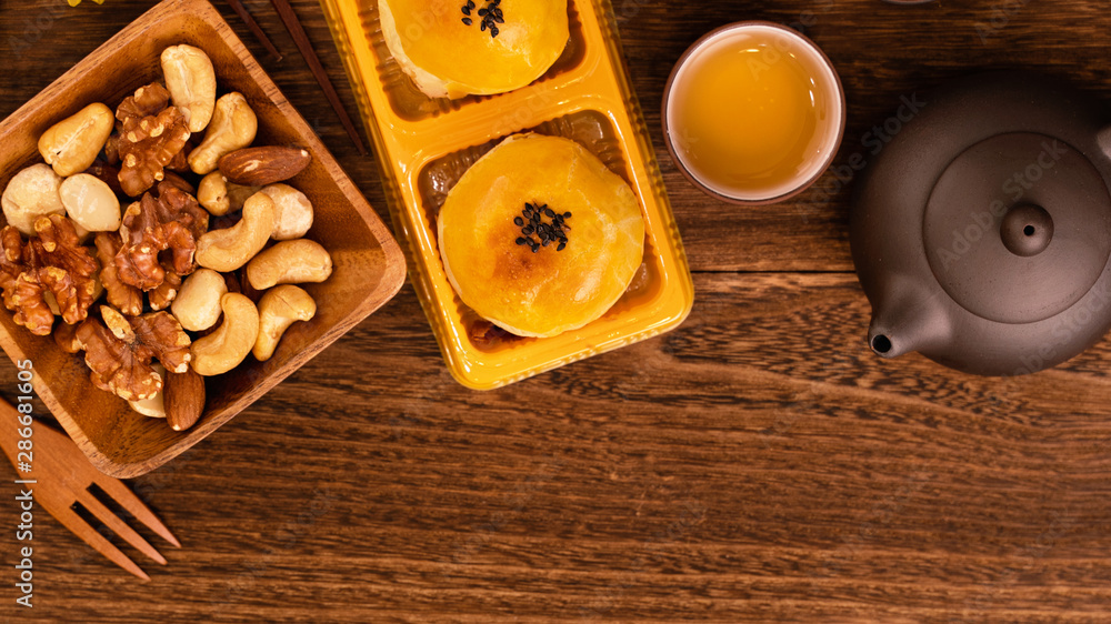 深色木桌上的月饼配茶，中秋节传统美食的节日理念la