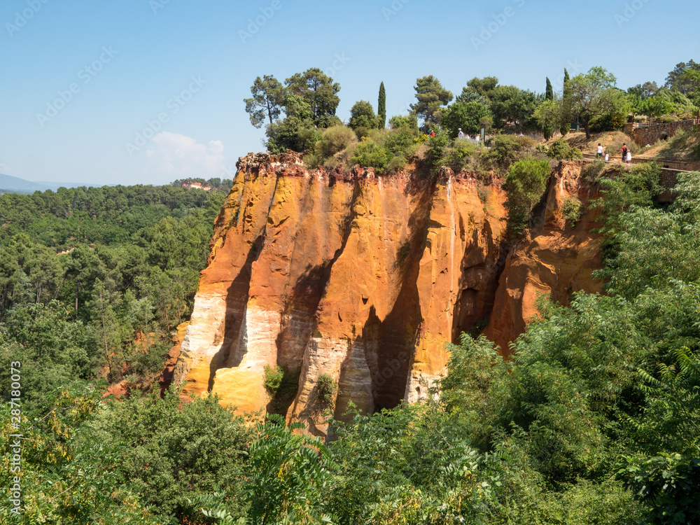 ROUSSILLON, France, august 2019: A view of the red ochre cliffs of Roussillon, ranked as one of the 