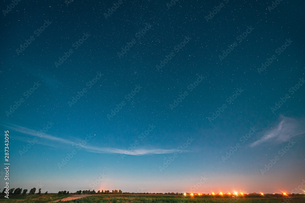 Night Starry Sky With Glowing Stars Above Landscape With City Lights. Night Starry Sky Above Ground.